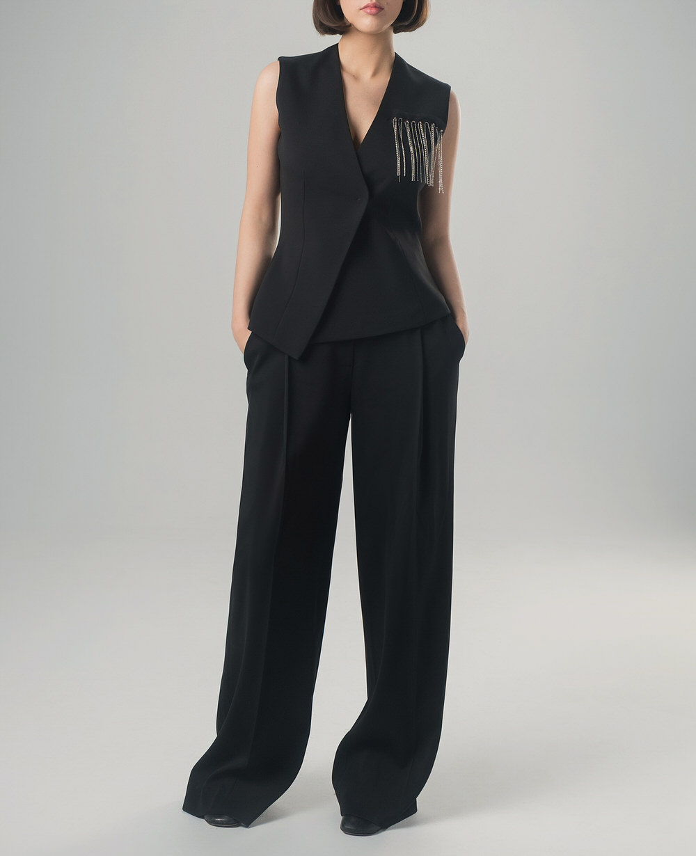 Black two-piece set with asymmetric vest and wide-leg trousers